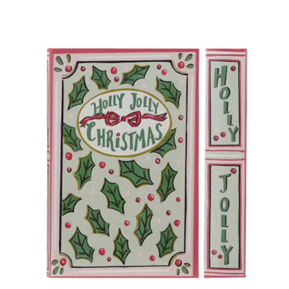 Holiday book-shaped decorative box reading "Holly Jolly Christmas" with holly leaves and red berries.