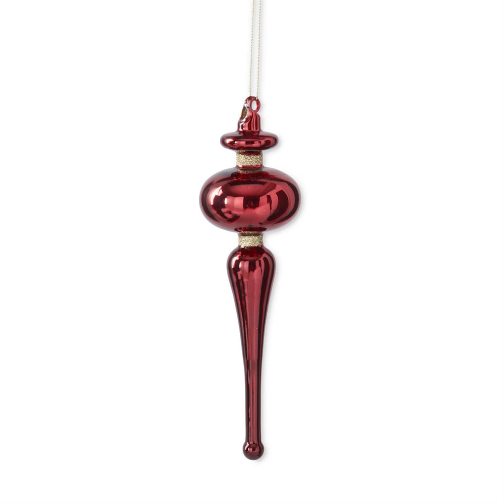A hanging red glass finial ornament with gold glitter trim.