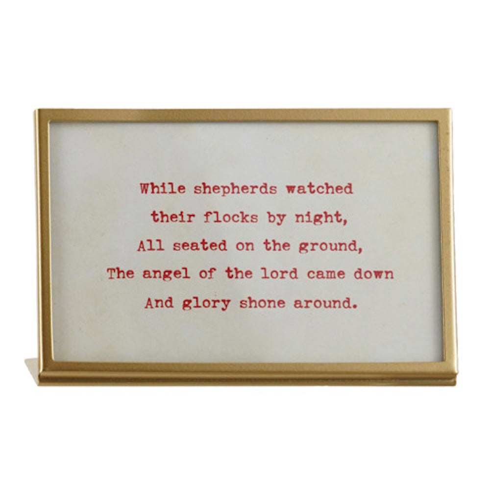 Brass glass easel frame displaying red printed Christmas carol verse about shepherds.