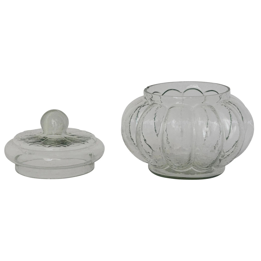 Clear ribbed glass pumpkin jar with a matching lid on a white background, ideal for home decor and storage.