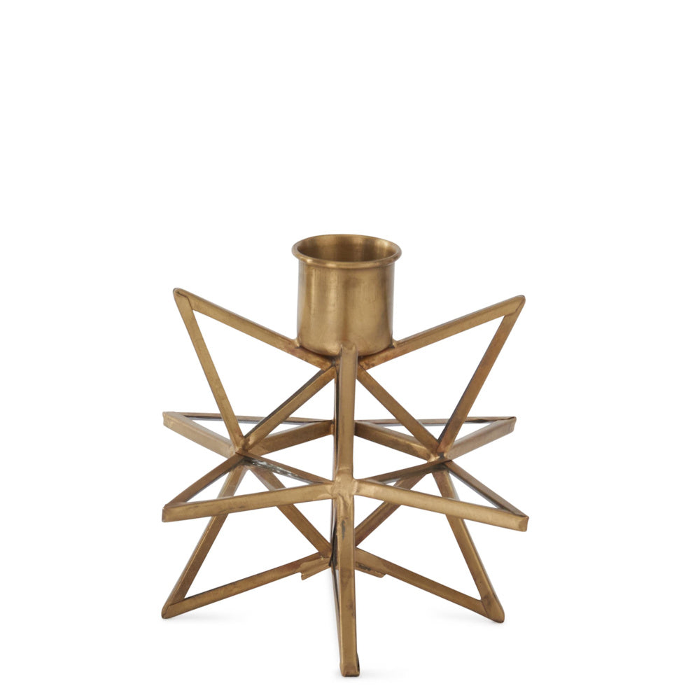 A small, three-dimensional gold metal star taper candleholder with glass panes on white background.