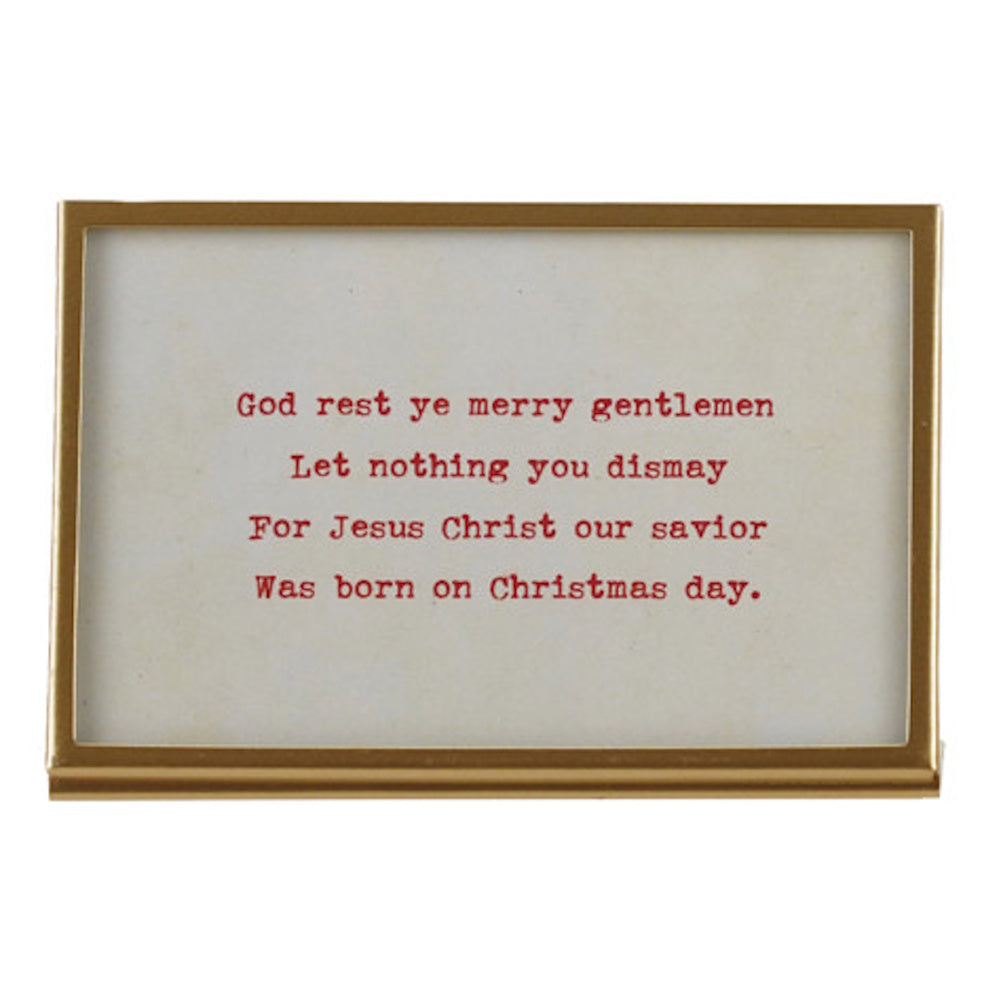 Gold framed desktop glass sign featuring red printed Christmas carol lyrics.