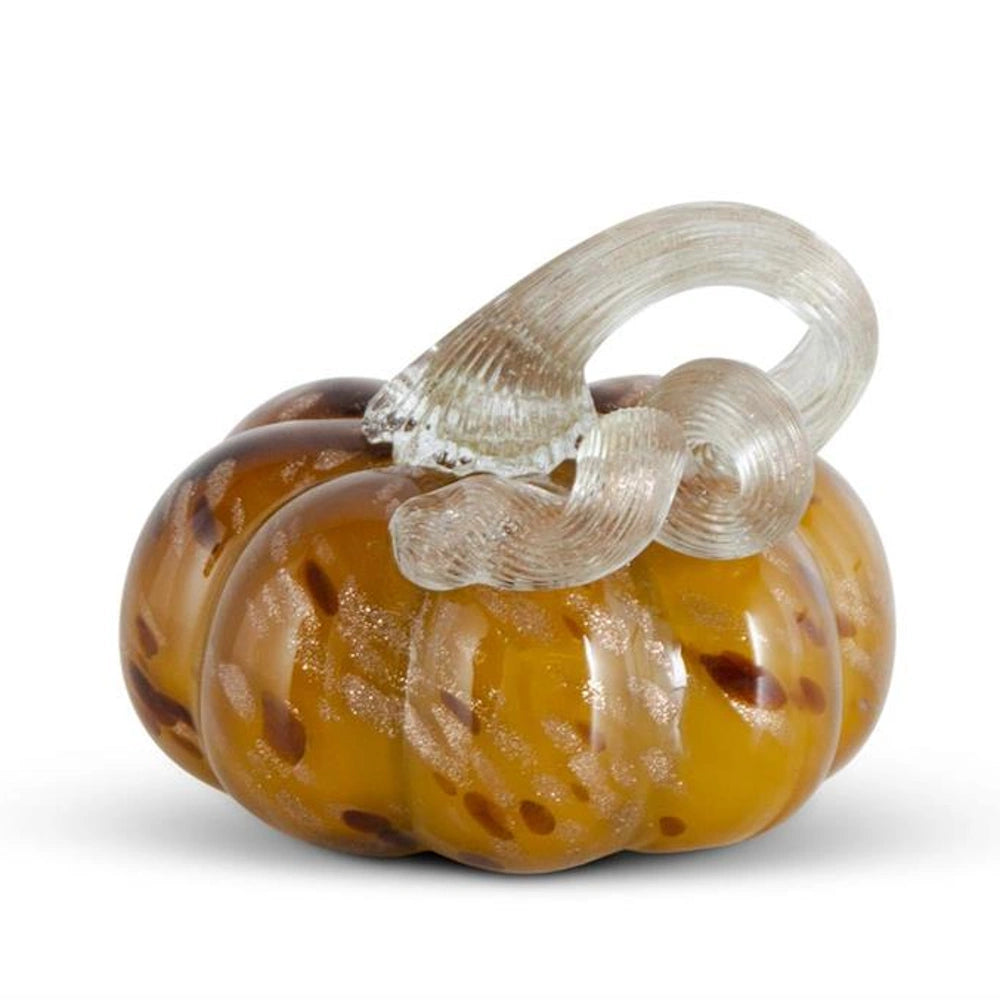 Yellow speckled handblown glass pumpkin with a curled clear stem for autumn and Thanksgiving home decor.