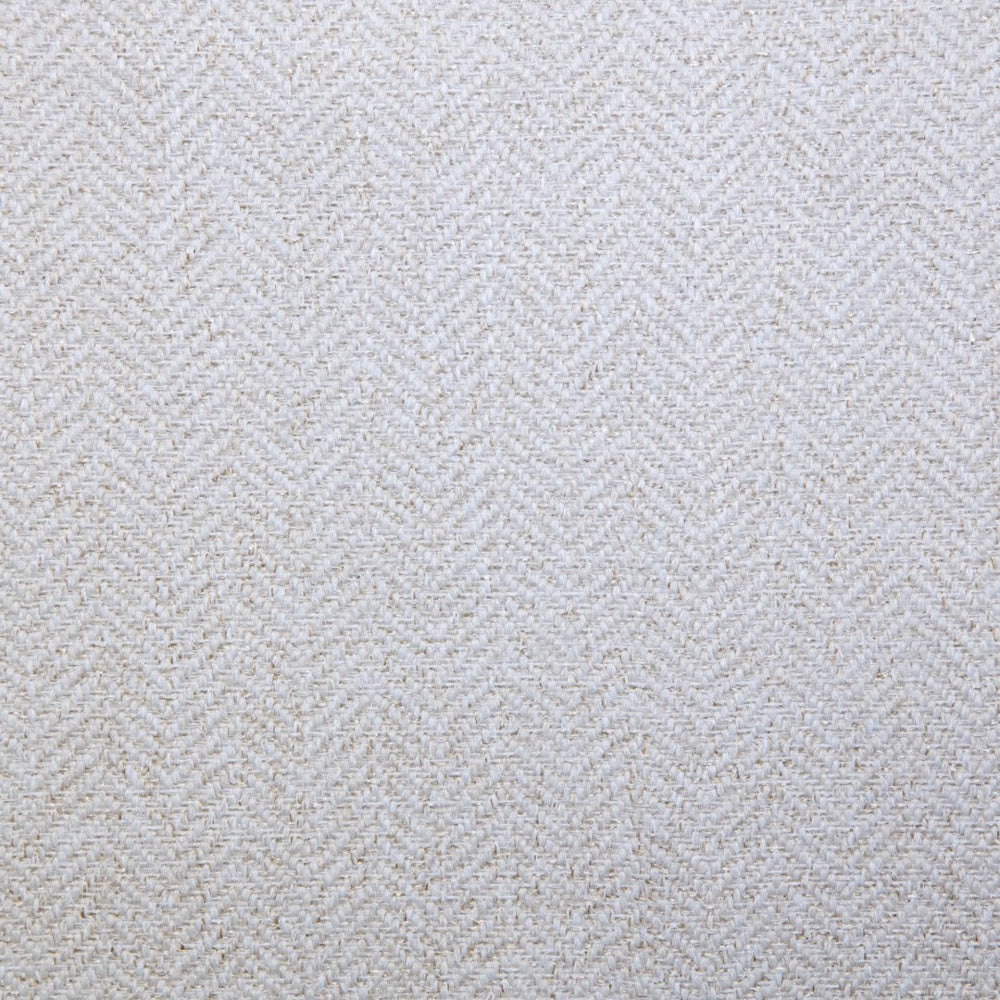 Close-up of white woven textured fabric with a subtle chevron pattern.