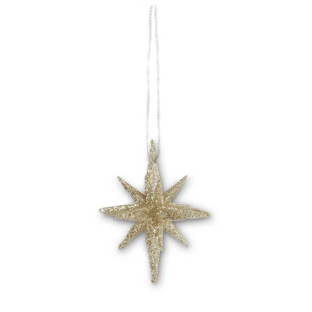 A nine-point champagne glitter star ornament hanging from a string.