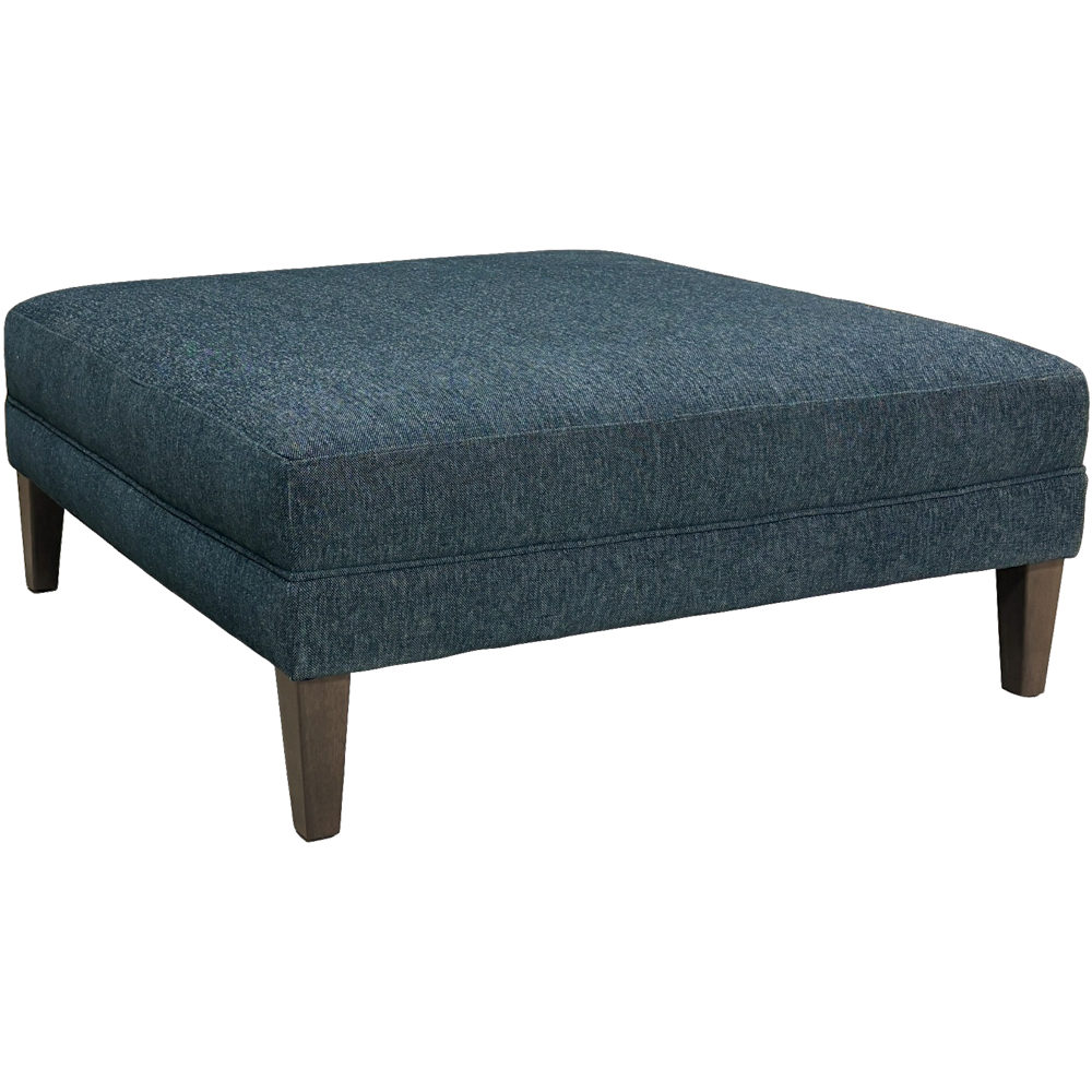 Square dark blue upholstered ottoman with low wooden legs on a black background.