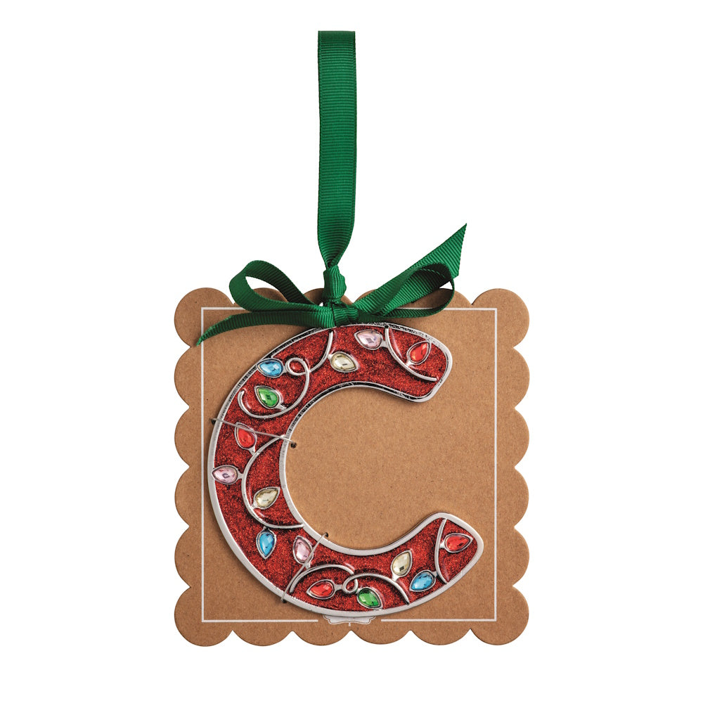 Sparkly red Christmas initial ornament letter C mounted on a scalloped brown card with a green hanging ribbon.