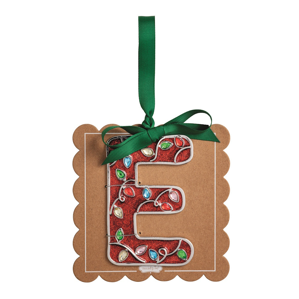 Sparkly red Christmas initial ornament letter E mounted on a scalloped brown card with a green hanging ribbon.