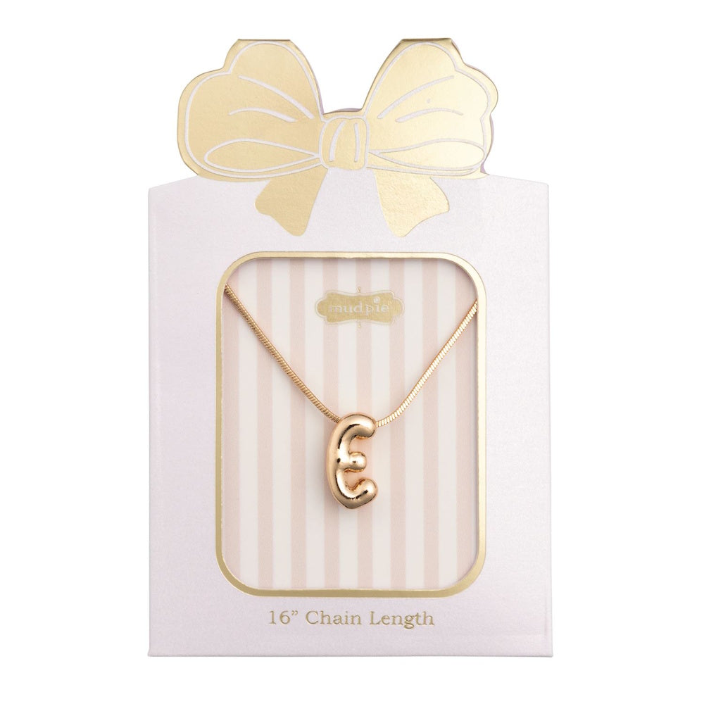 Gold initial "E" pendant necklace packaged in a pink box with a gold bow design.