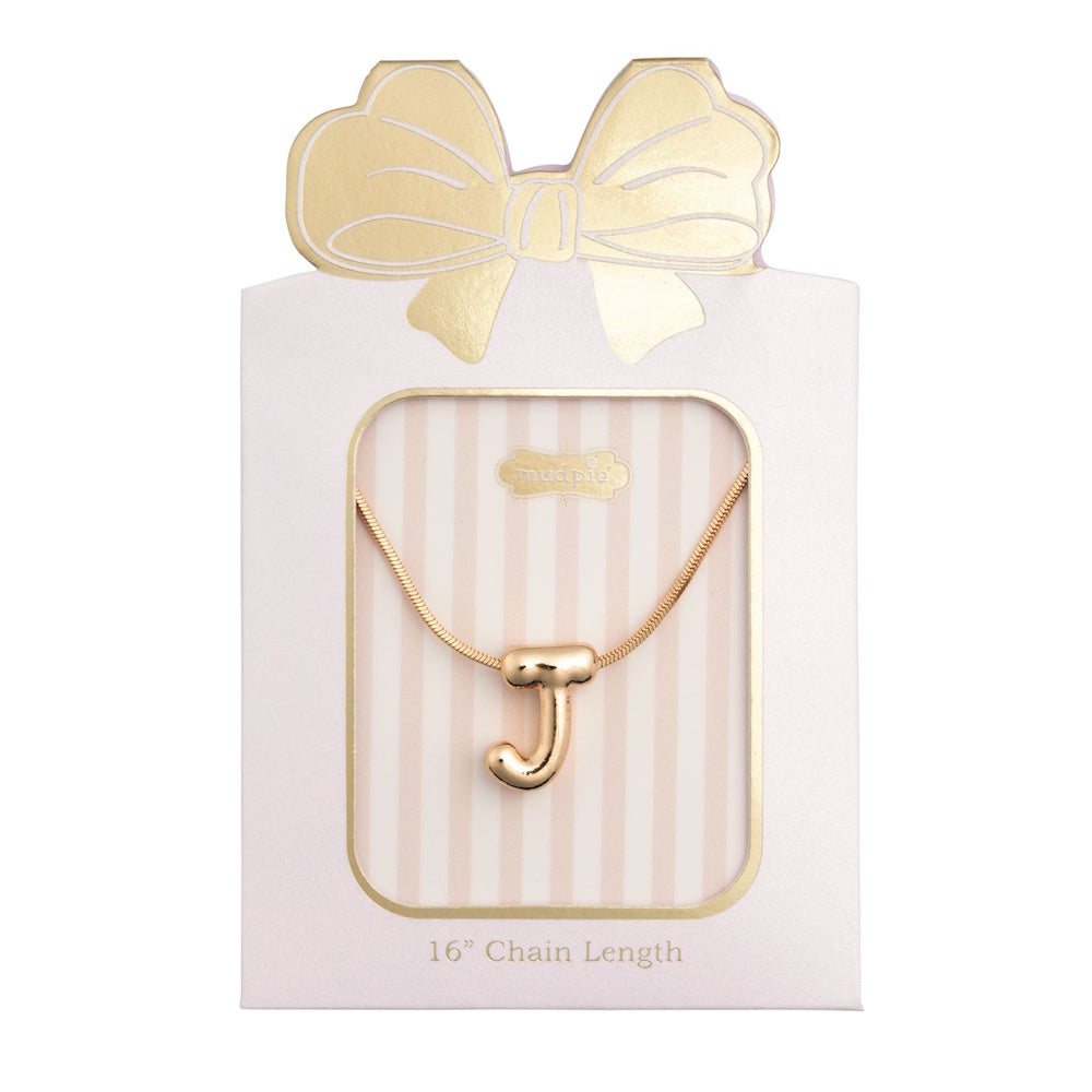 Gold initial "J" pendant necklace packaged in a pink box with a gold bow design.