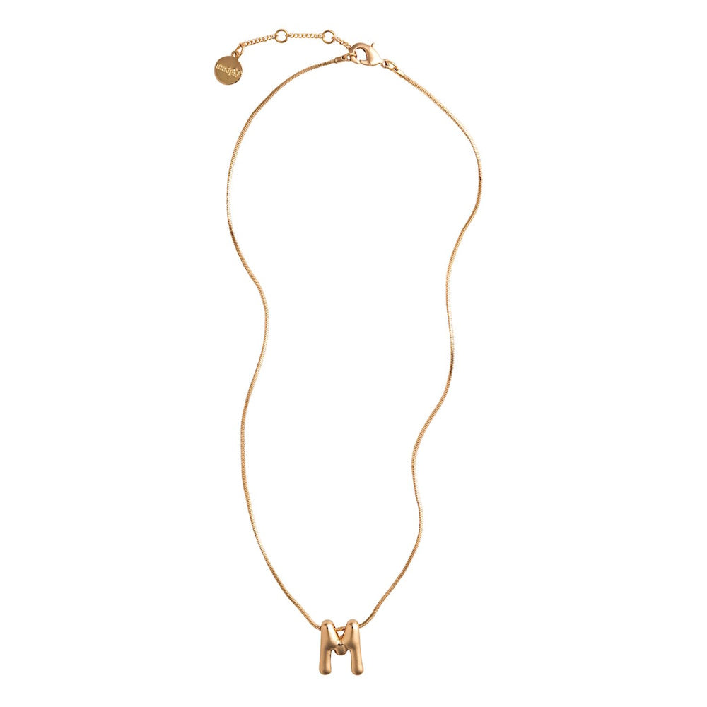 Gold necklace featuring a puffy, bubble-style initial letter M pendant on a thin snake chain.