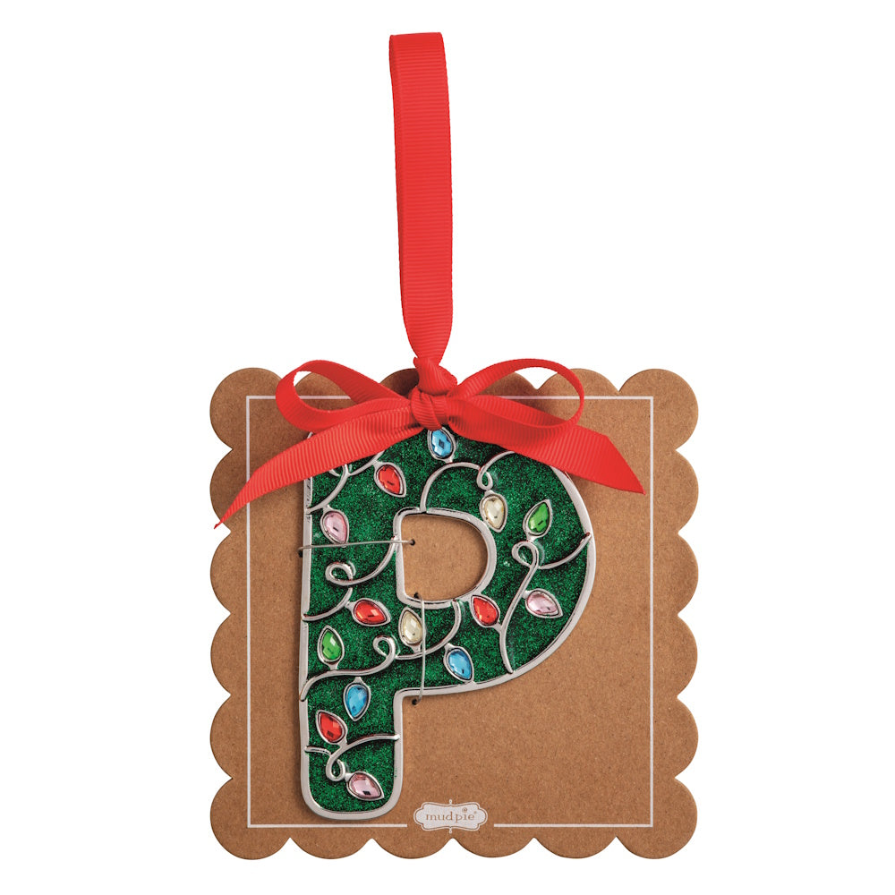 Sparkly green Christmas initial ornament letter P on a scalloped brown card with a red hanging ribbon.