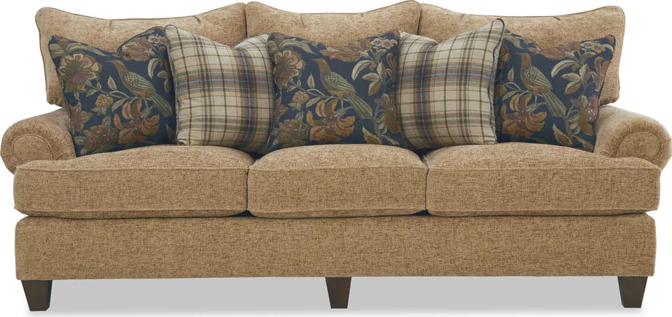 Front view of the Paula Deen Home Audrey sofa in Praline upholstery with three seat cushions, three floral pillows, two plaid pillows, and tapered wood legs.