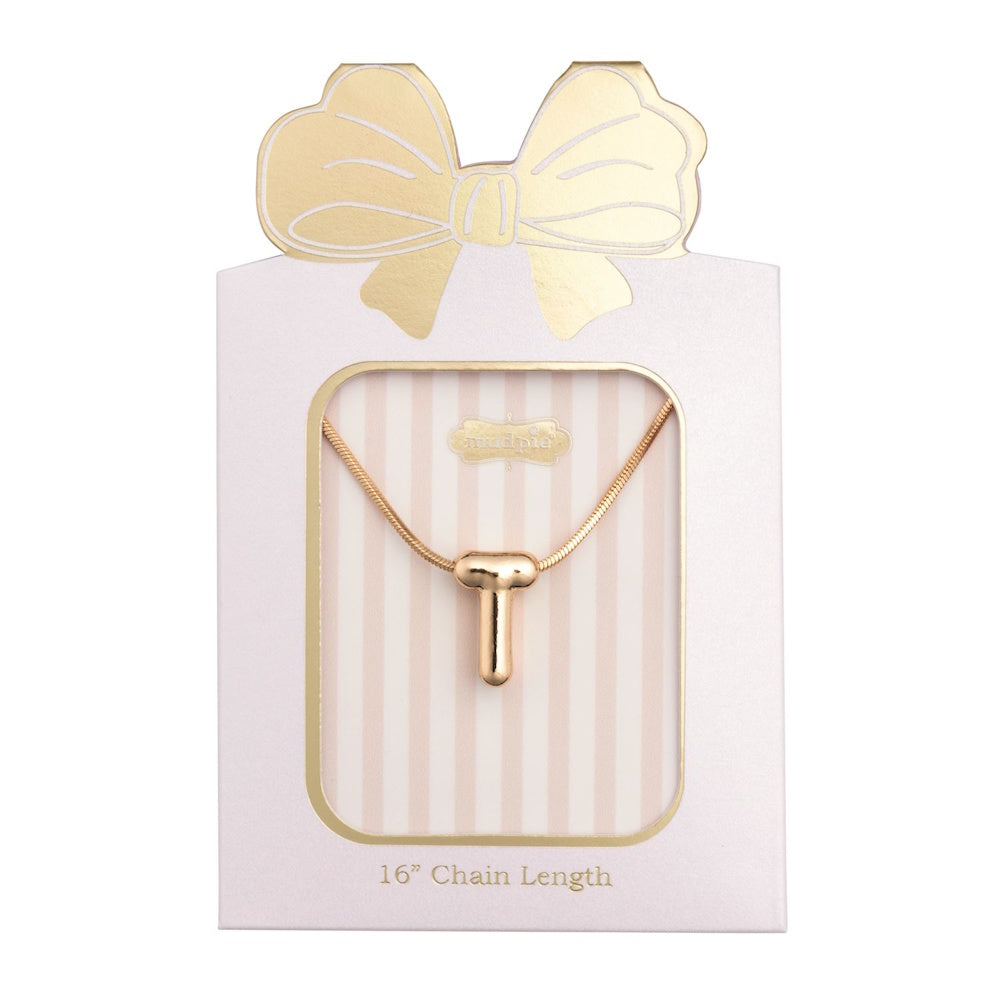 Gold initial "T" pendant necklace packaged in a pink box with a gold bow design.