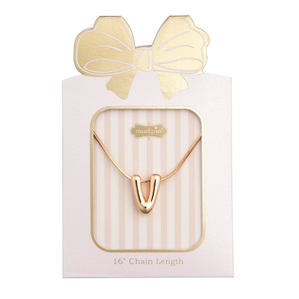 Gold initial "V" pendant necklace packaged in a pink box with a gold bow design.