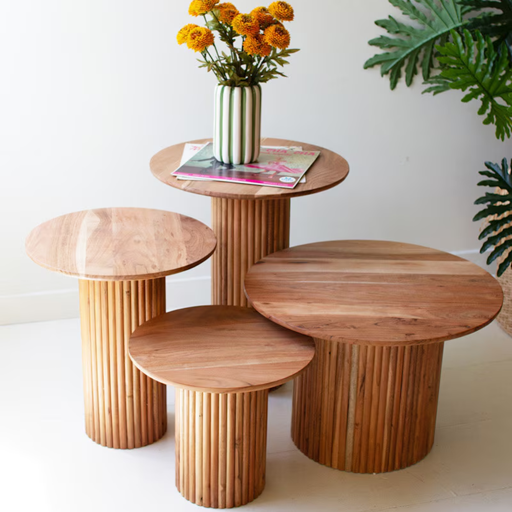 Group of four round acacia wood accent tables with ribbed tambour bases in varying sizes.