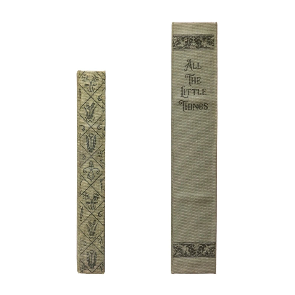 Two decorative canvas book storage boxes, one titled "All The Little Things," featuring vintage floral patterns on the spine.