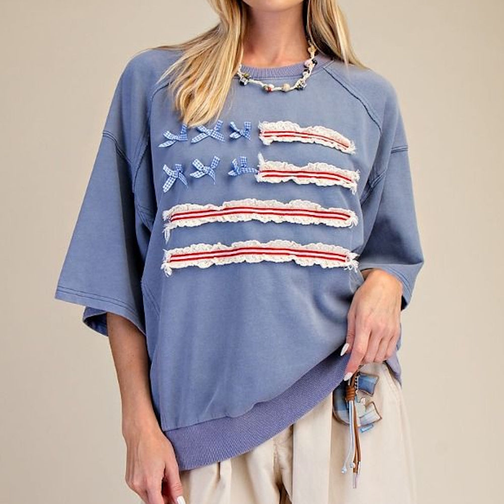 Blue oversized sweatshirt with American flag design made of ruffled ribbon stripes and gingham bows.