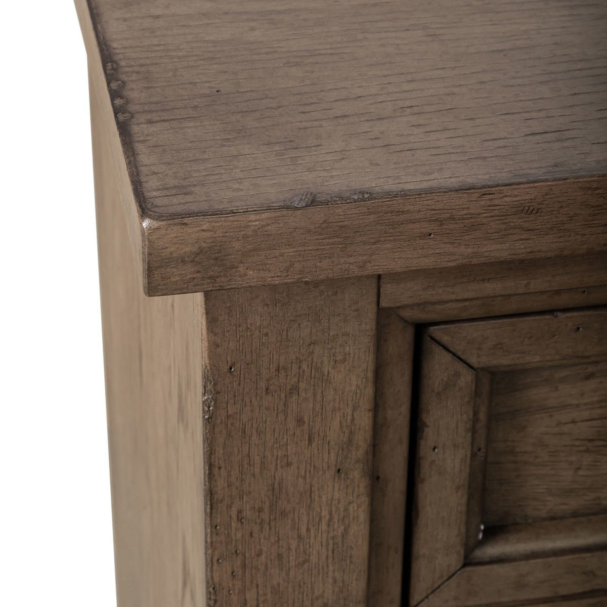 Close-up of the wooden dresser top corner showing the distressed finish and mitered frame details.