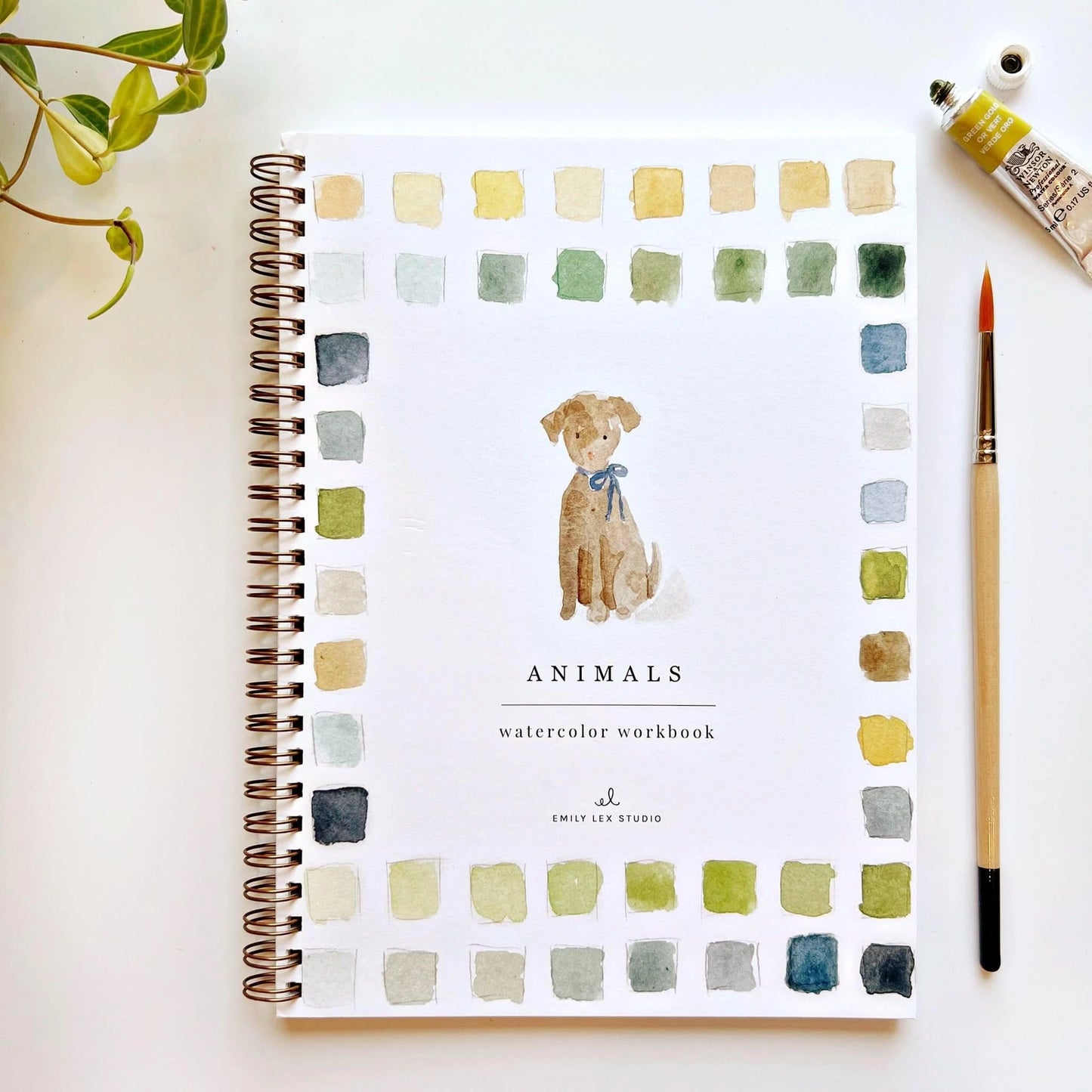 Animals watercolor workbook cover featuring a dog painting, color swatches, paint, and brush.
