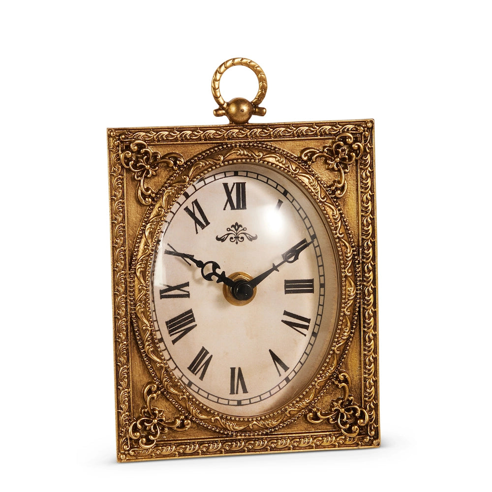 Ornate gold-framed clock with Roman numerals and vintage hands. The frame features intricate floral patterns, conveying an antique, elegant feel.