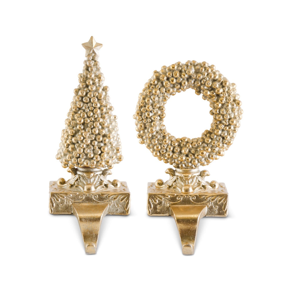 Set of 2 champagne gold berry stocking holders shaped as a tree and a wreath on a white background.