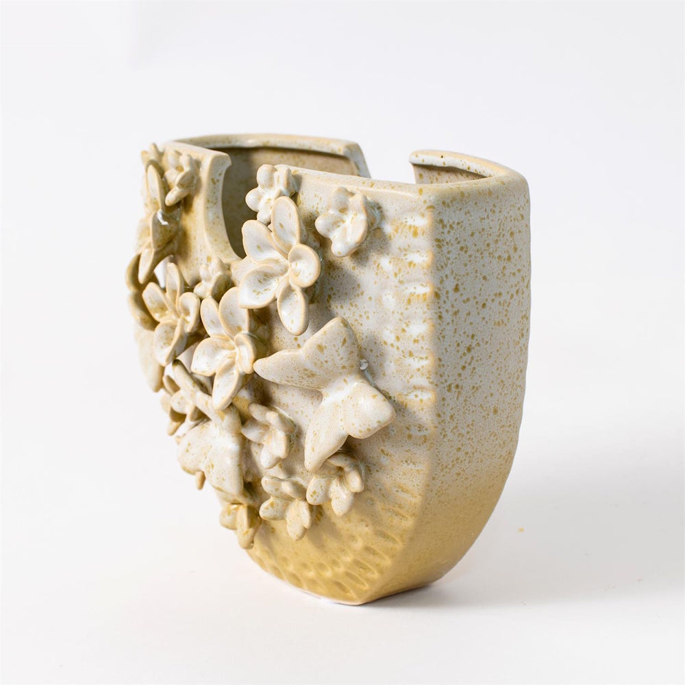 Textured ceramic butterfly and flower vase in a cream and yellow speckled glaze, featuring a unique 3D applied design.