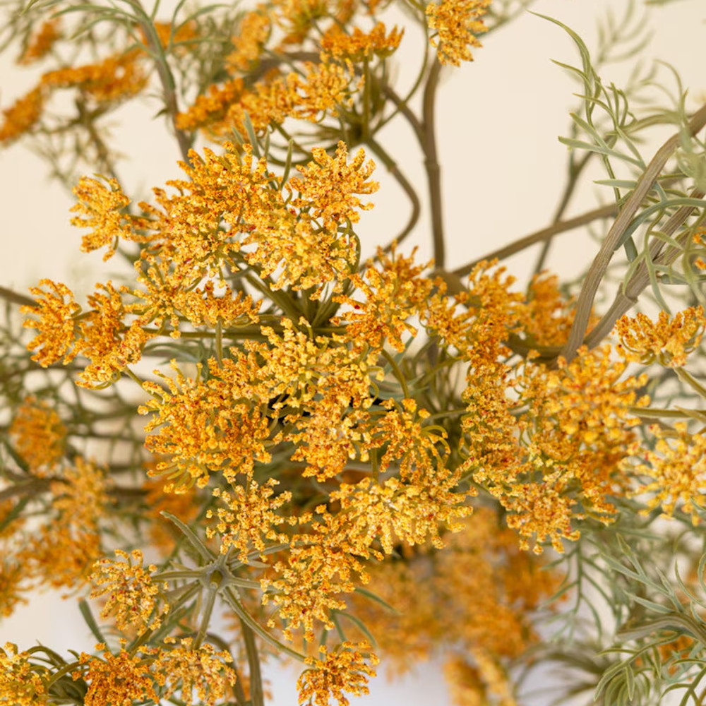 Close-up view of textured, vibrant yellow lace flower clusters on delicate faux stems.