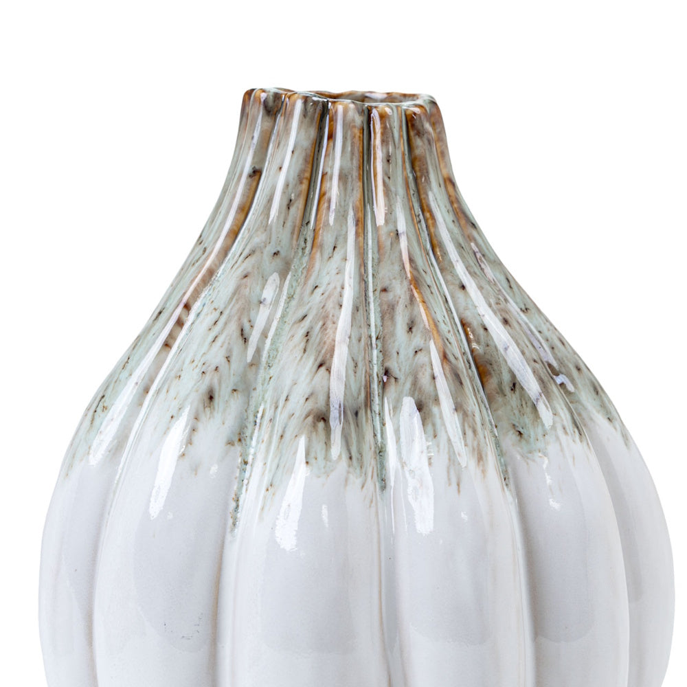 Close-up of a white Audrix short vase with vertical ribbing and a speckled brown and teal reactive glaze at the neck.