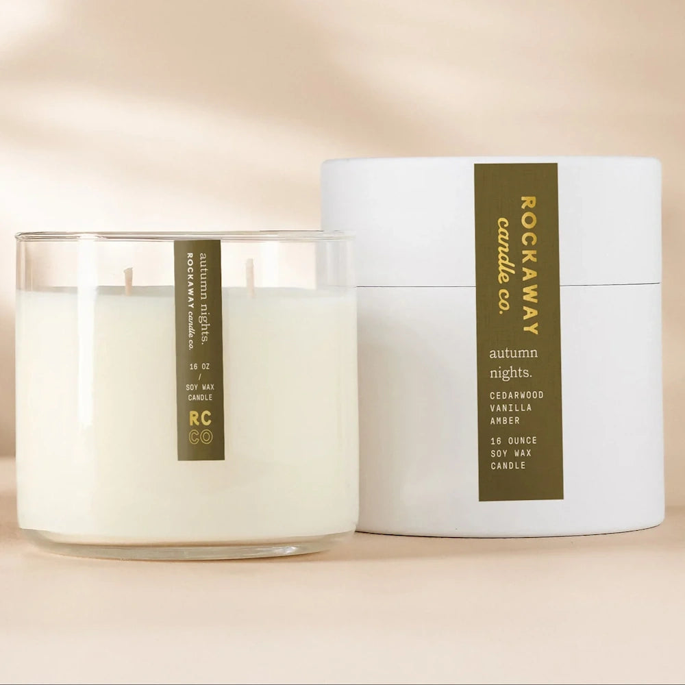 Rockaway Candle Co. Autumn Nights 16 oz soy wax candle in a glass jar next to its white gift box packaging.