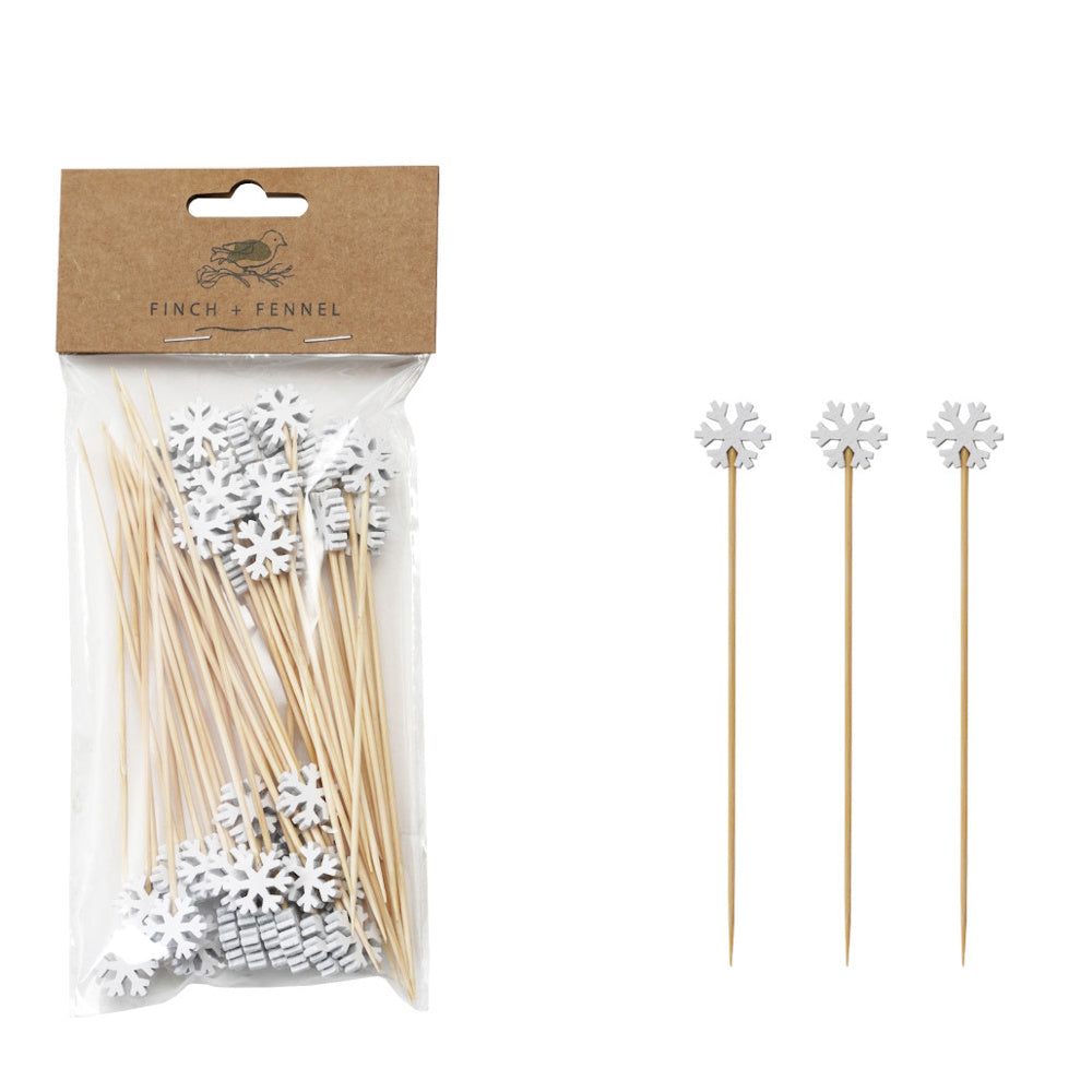 Bamboo skewers topped with white snowflake handles, shown in a package and individually lined up.