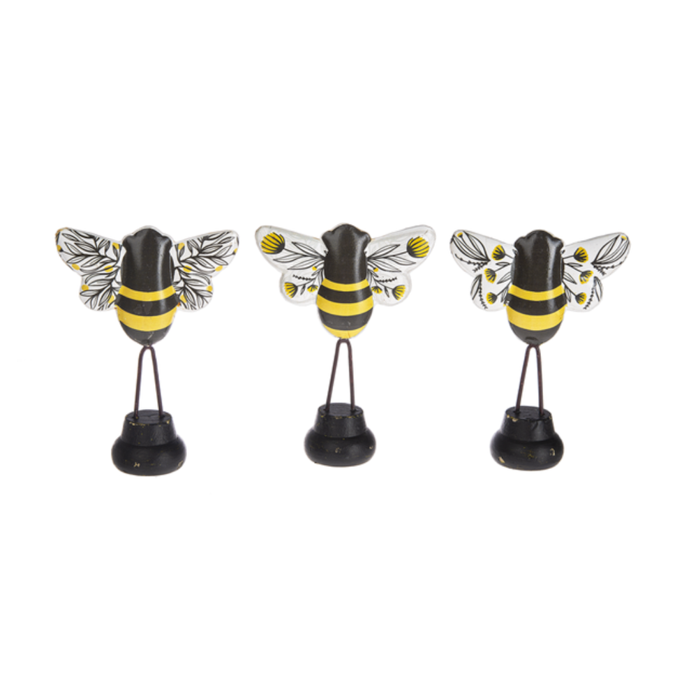 Three small bumblebee figurines with yellow and black striped bodies and decorated wings on wire stands.