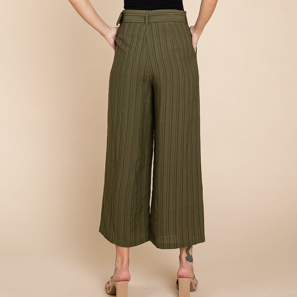 Back view of a person wearing olive green, striped wide-leg cropped trousers with heels.