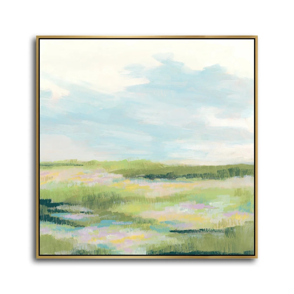 Abstract landscape painting of a green meadow and blue sky in a gold frame.