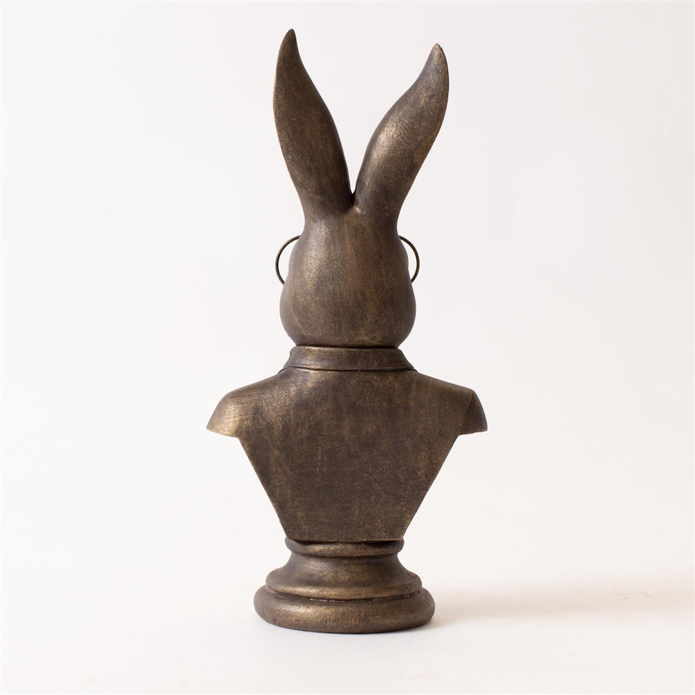 Back view of a bronze rabbit bust figurine wearing glasses and a suit coat on a white background.