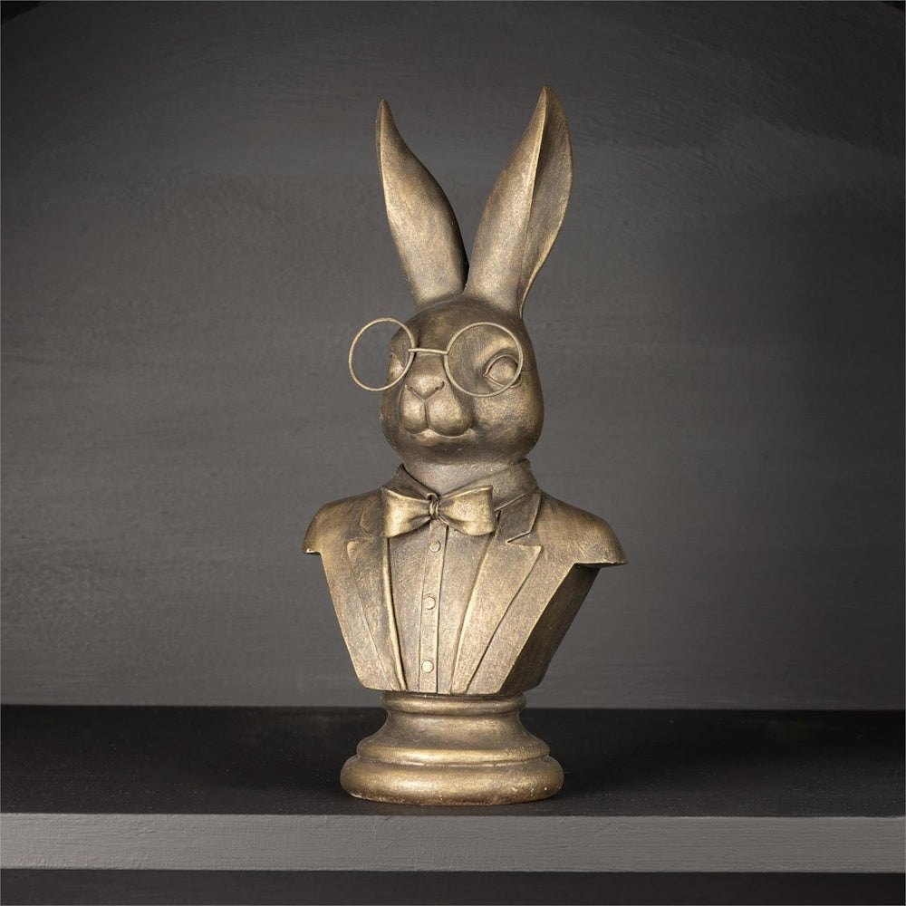 Bronze rabbit bust sculpture wearing round glasses, a suit jacket, and a bow tie.