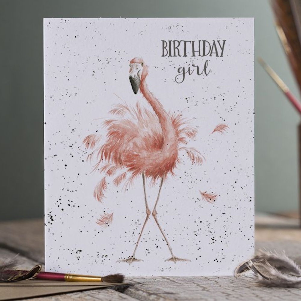 Watercolor pink flamingo birthday card with "Birthday girl" text, whimsical feathers, and black paint splatters.