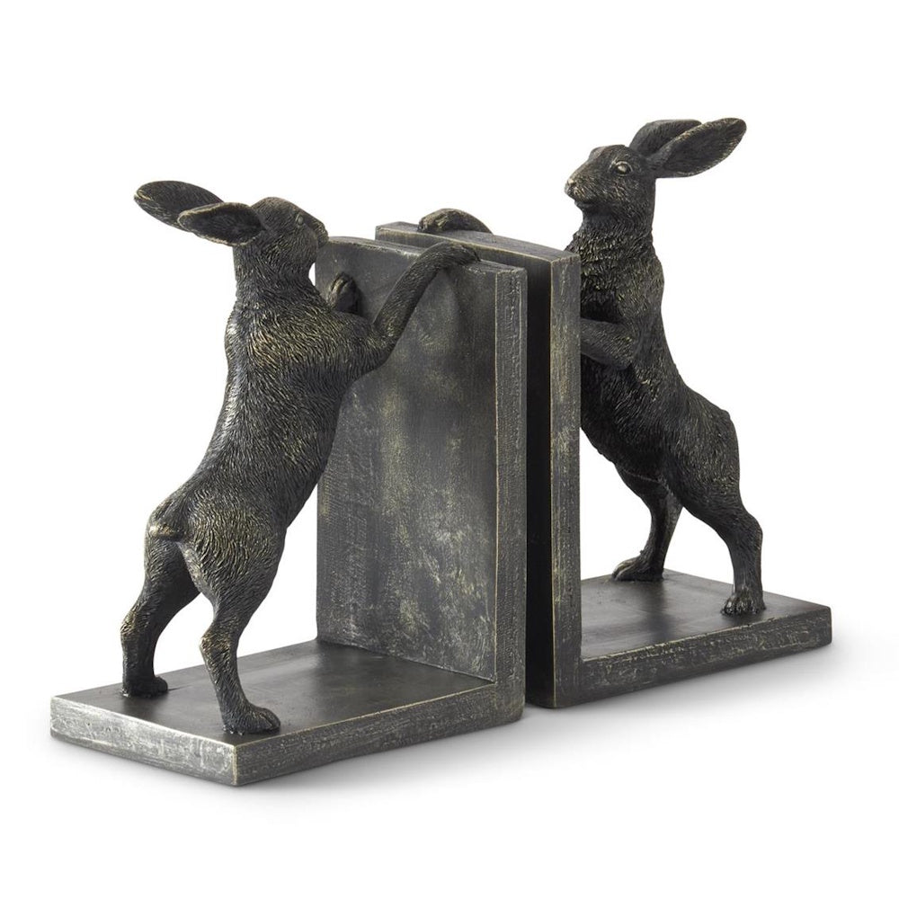 A pair of bronze rabbit bookends pushing against L-shaped stands.