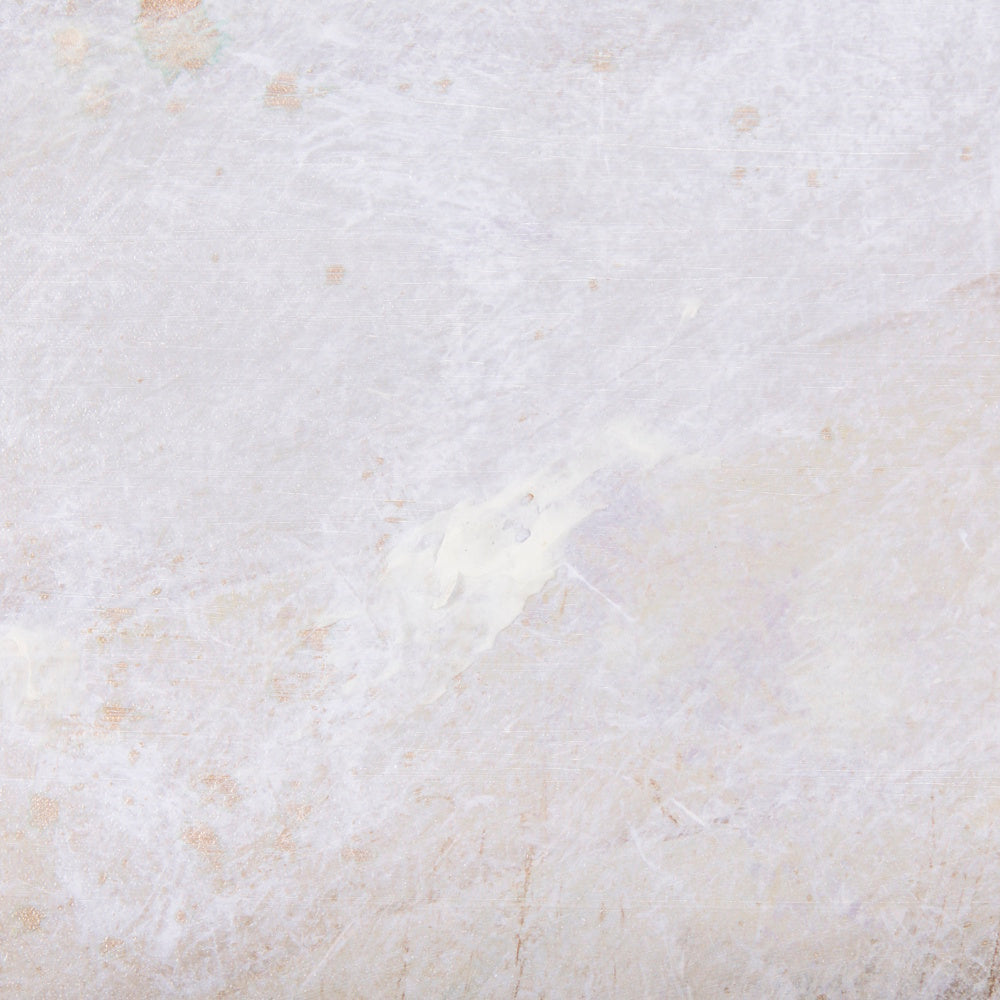 Extreme close-up of the textured, light-toned surface of the hand-embellished abstract canvas art.