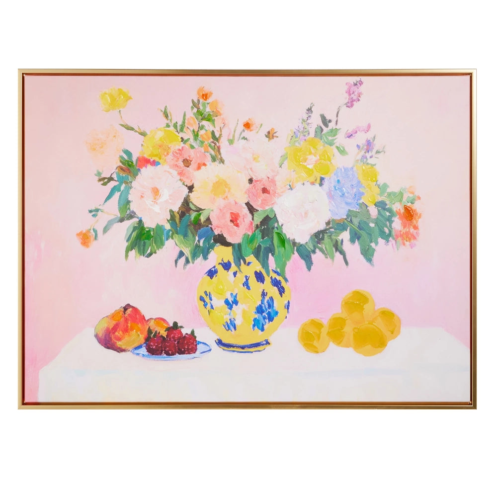 An impressionist oil painting of colorful flowers in a yellow patterned vase with fruit on a white table.