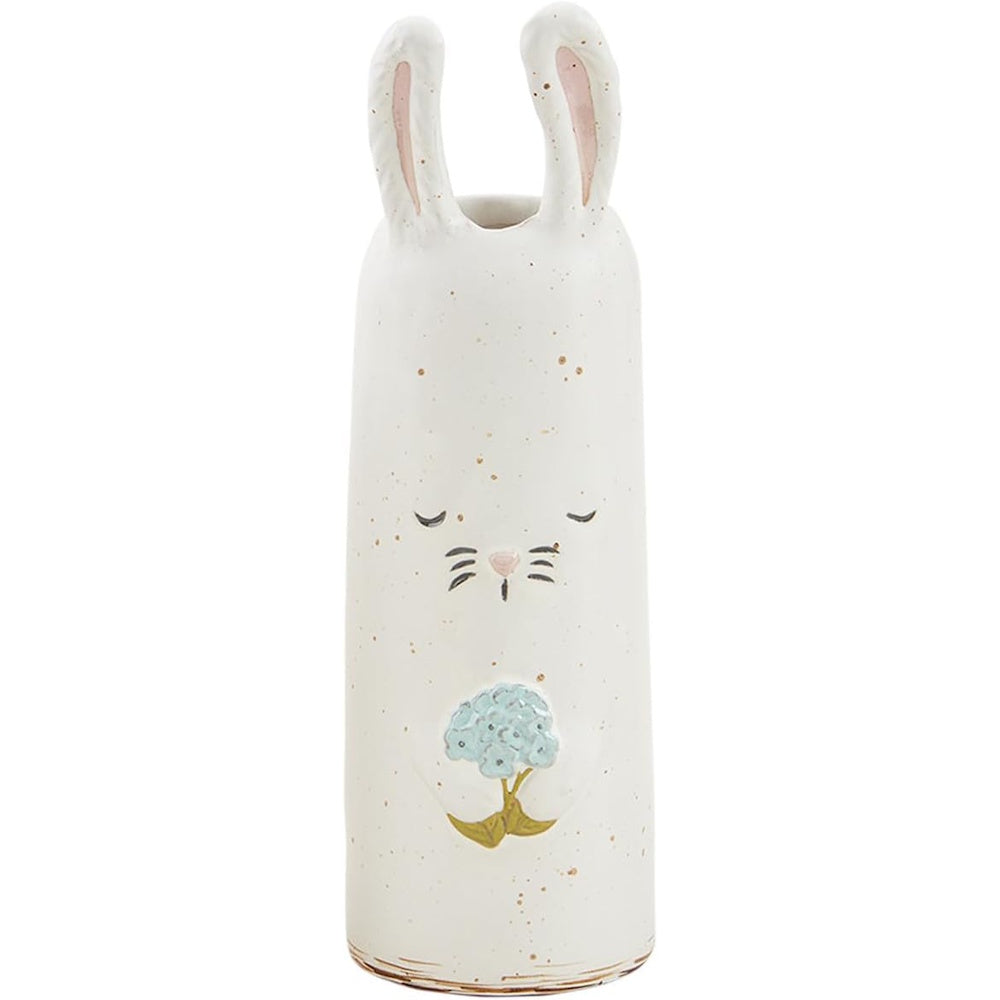 A tall, white ceramic bunny-shaped vase holding a blue flower, featuring a speckled finish and closed eyes.