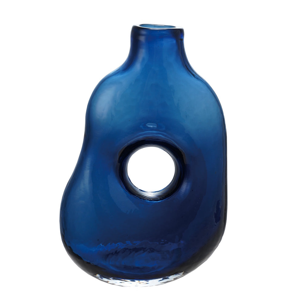 An abstract, cobalt blue glass vase with an organic, asymmetrical shape and a circular cutout in the center.