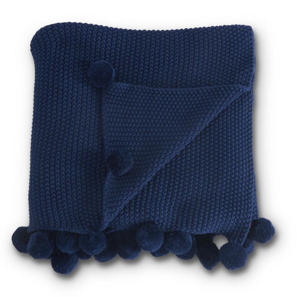 Navy blue moss stitch knit throw blanket with pompom trim and folded corner.