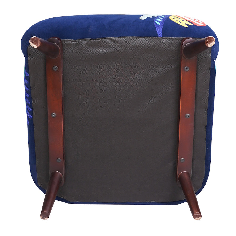 Bottom view of navy blue floral accent chair showing upholstered base, wooden support rails and angled legs.