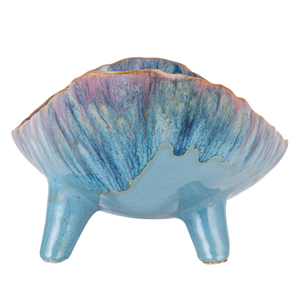 Blue stoneware footed organic shaped bowl with a reactive glaze in shades of turquoise, purple, and brown.