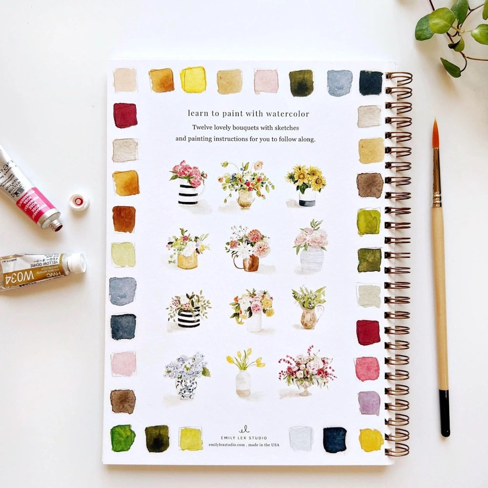 Watercolor sketchbook page with floral bouquet illustrations, color swatches, paint tubes, and a brush.