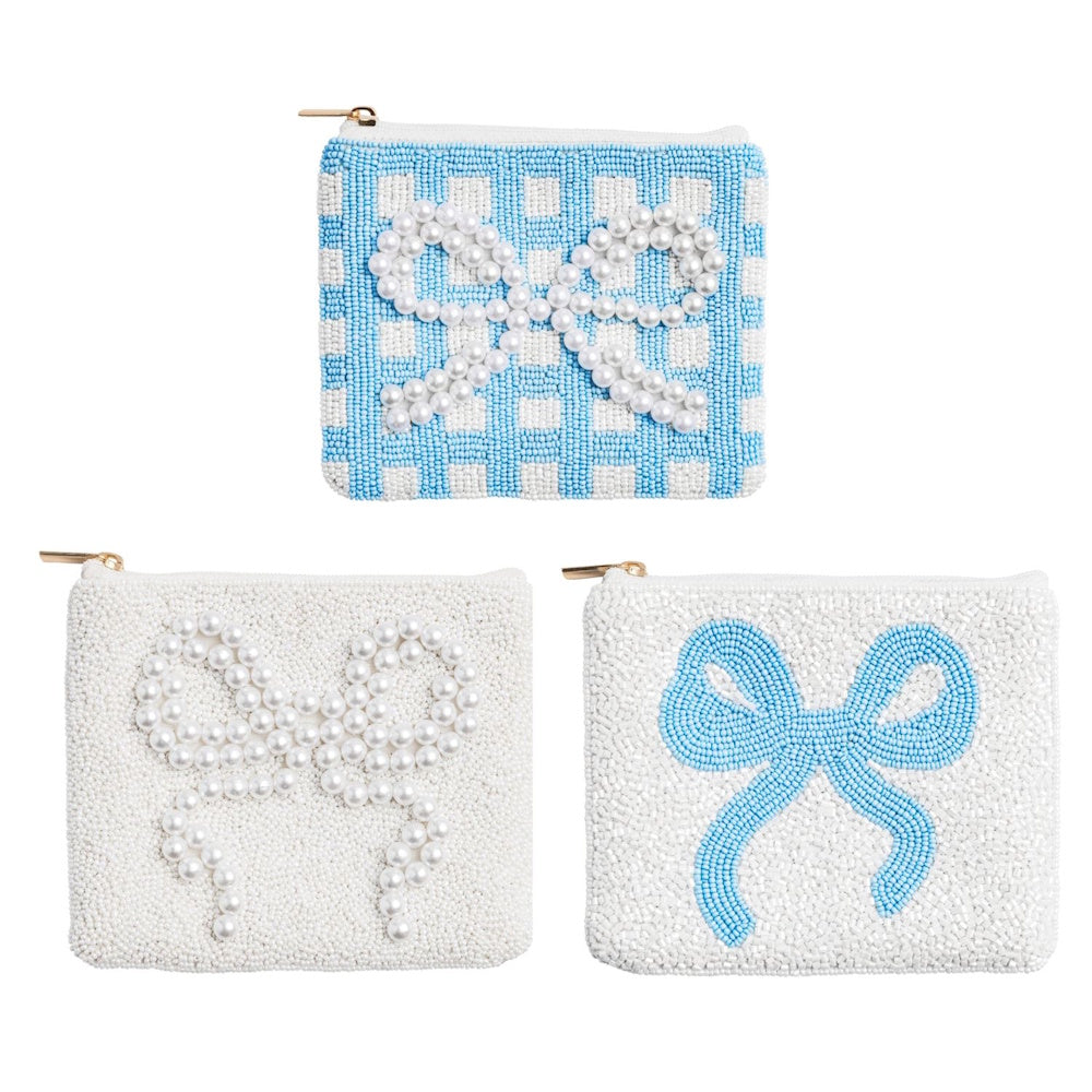 Three beaded coin purses with bow designs in blue gingham, solid white, and white with a blue bow.