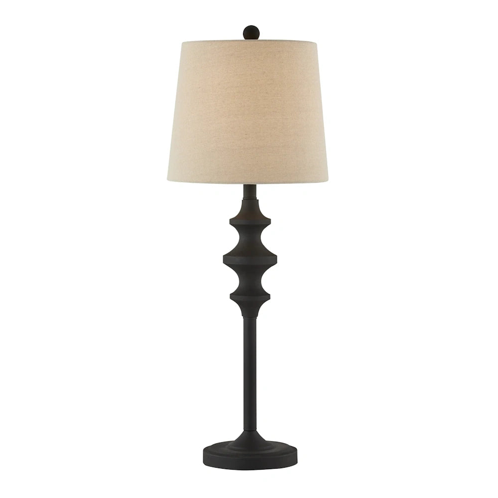 Black metal buffet table lamp with sculpted stem, round base and beige tapered fabric shade.
