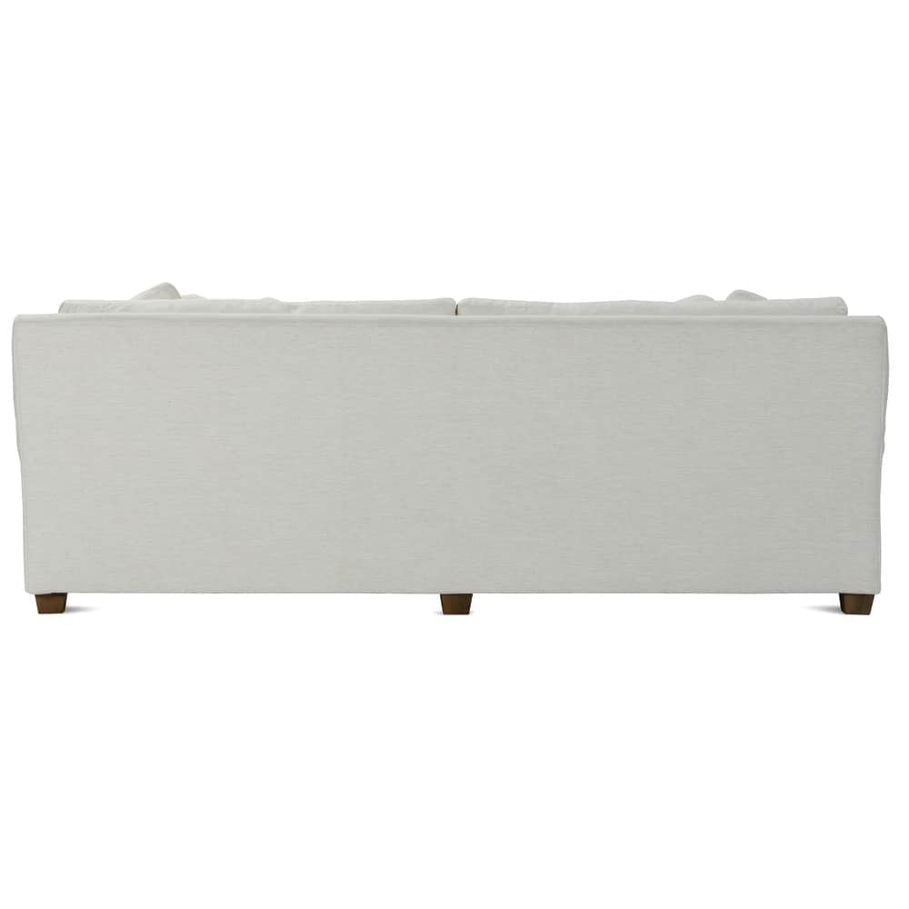 Back view of a Bristol sofa in cream fabric with wooden legs.