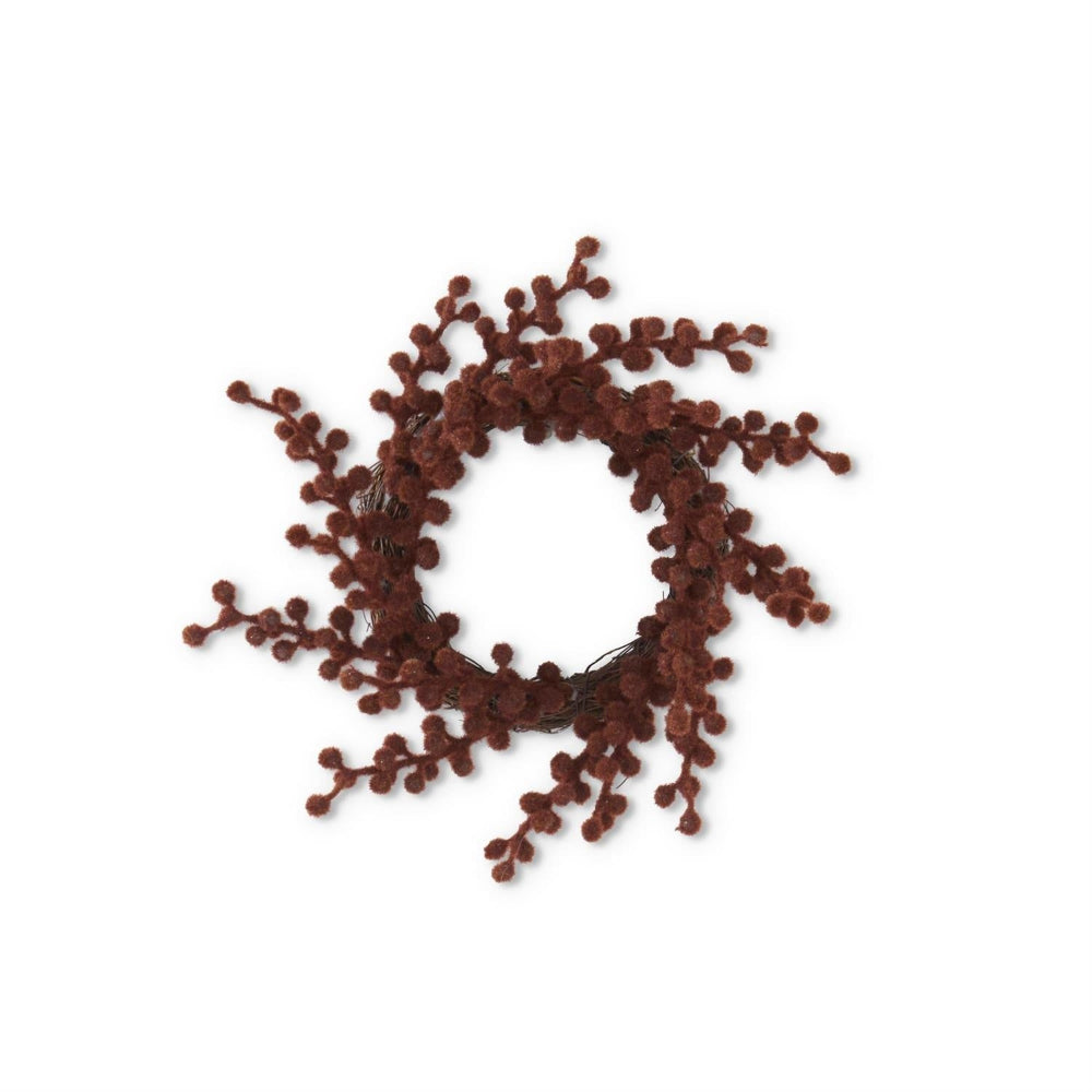 A small wreath or candle ring made of brown, textured, flocked berries on a twig base.